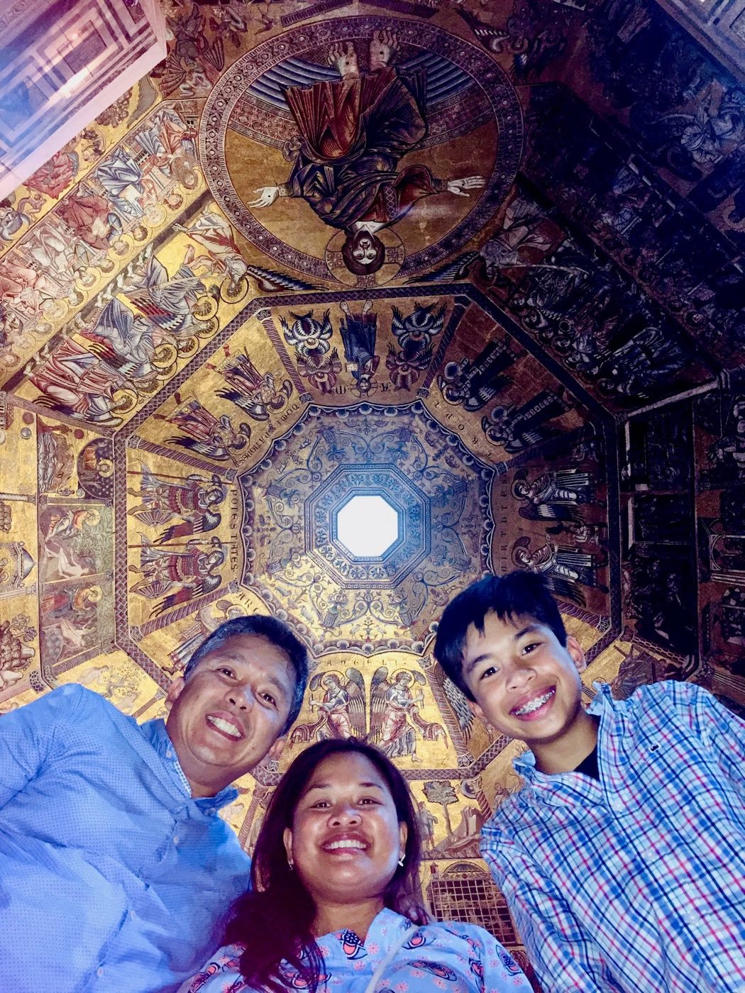 Renato Cruz Sogueco and family beneath the mosaic dome of the Florence Baptistery