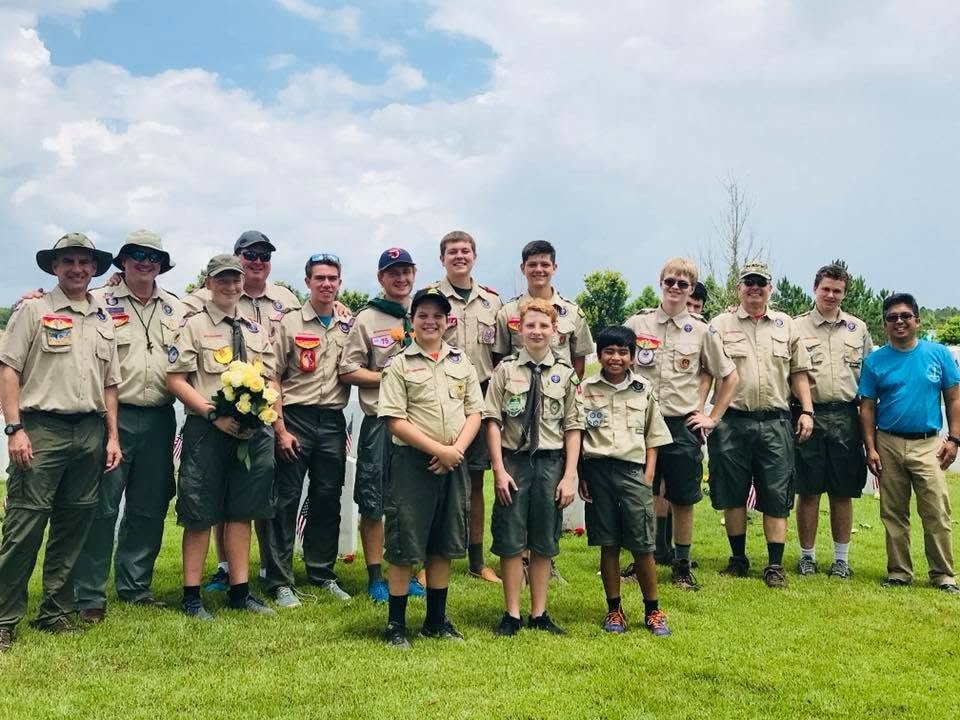 Renato Cruz Sogueco with a scout troop after placing flowers at a veterans cemetery